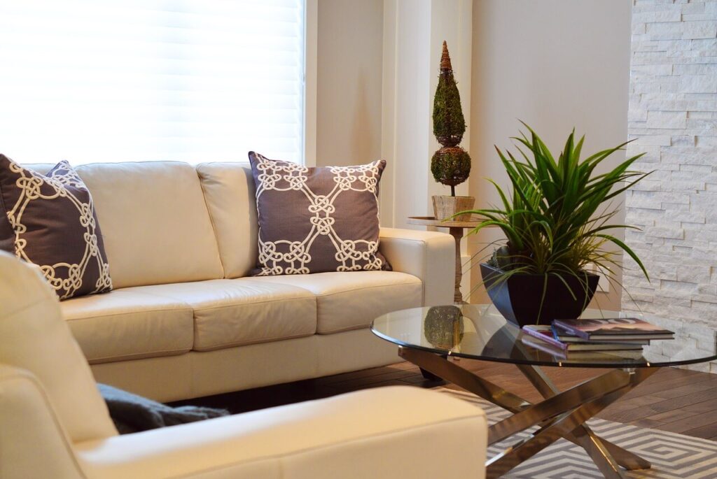 living room with white couches and glass table