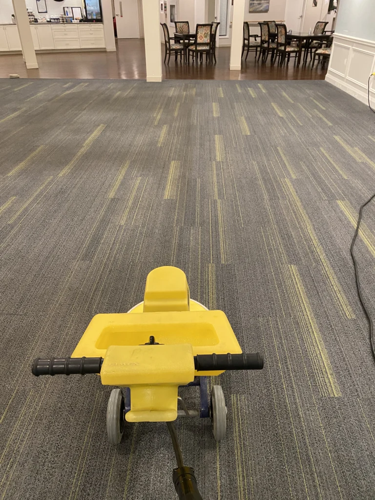 yellow machine cleaning commercial carpet